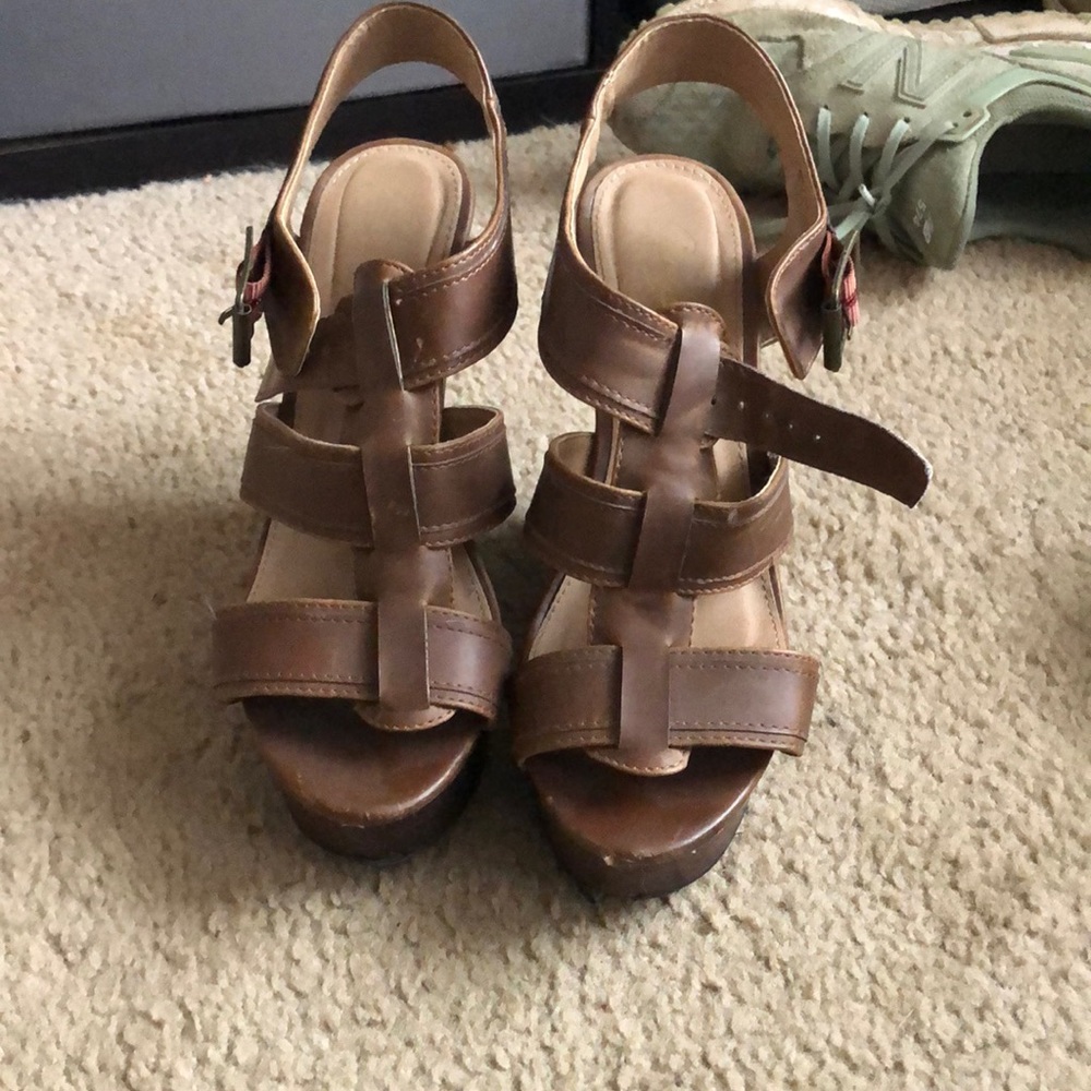 Brown wedges with slight tear on toe.